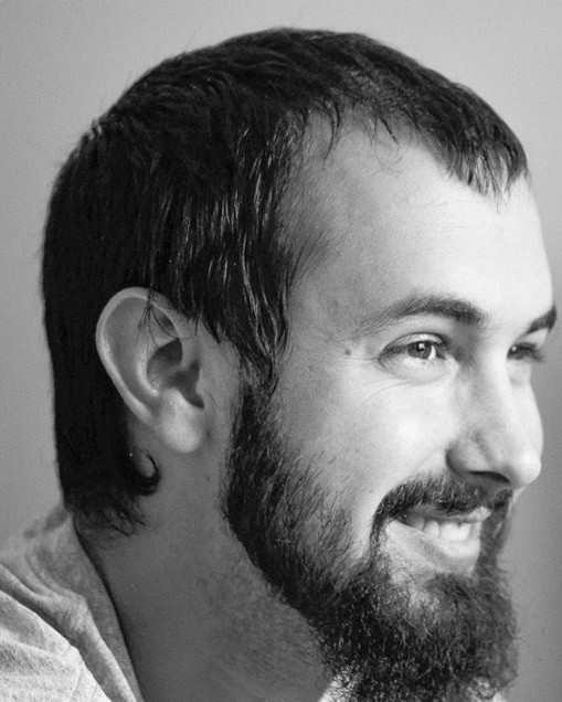 Candid black and white portrait of Jonathan Reeves smiling